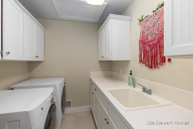 2445 Honey Creek Ave NE, Ada, MI 49301 - washroom with cabinet space, washing machine and dryer, light tile patterned floors, attic access, and baseboards