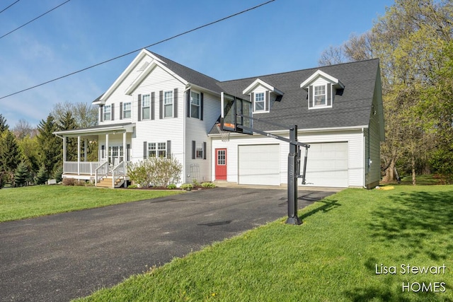 2445 Honey Creek Ave NE, Ada, MI 49301 - view of front facade with driveway, a porch, a front lawn, and a garage