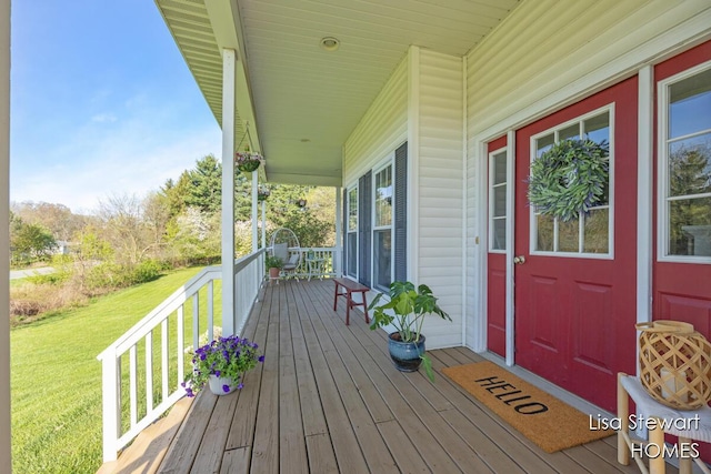 2445 Honey Creek Ave NE, Ada, MI 49301 - wooden deck with covered porch and a lawn
