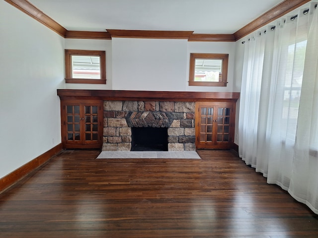 unfurnished living room with crown molding, plenty of natural light, wood-type flooring, and a fireplace