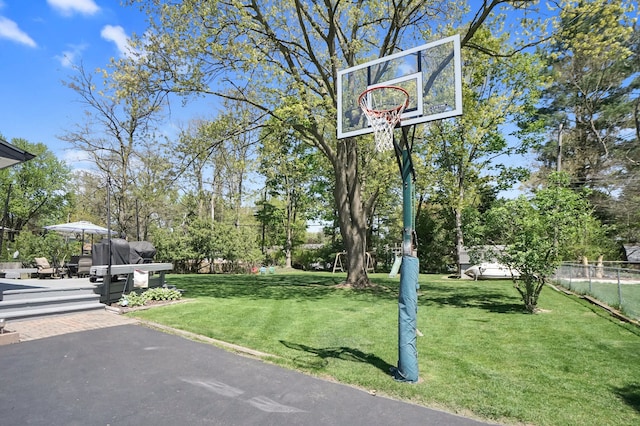 view of sport court with view of scattered trees