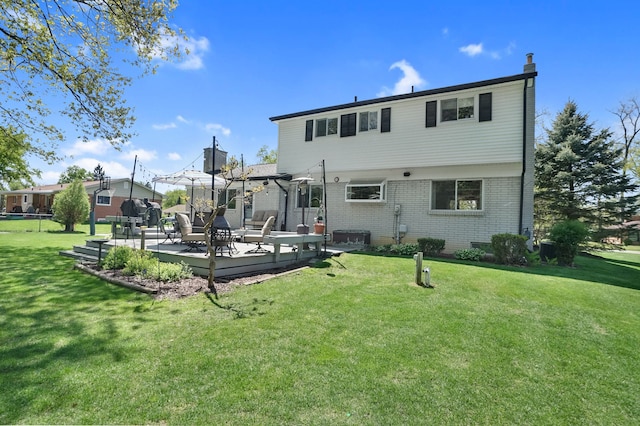 back of house featuring brick siding, a lawn, and a chimney