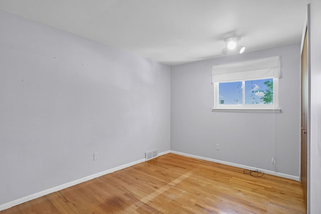 unfurnished room featuring light wood-type flooring and baseboards