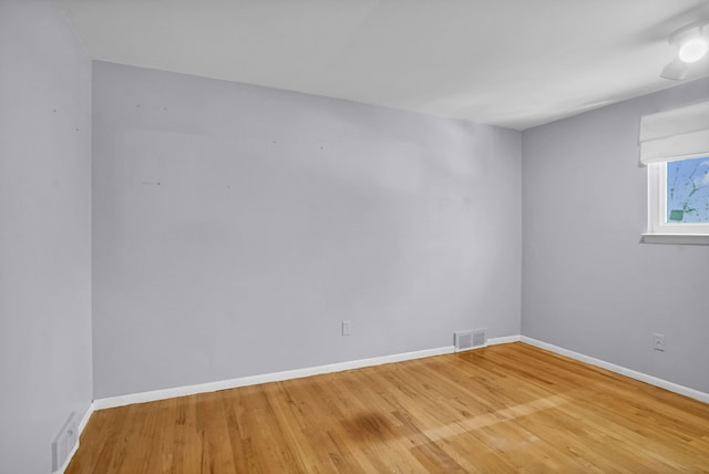 unfurnished room featuring wood finished floors and baseboards
