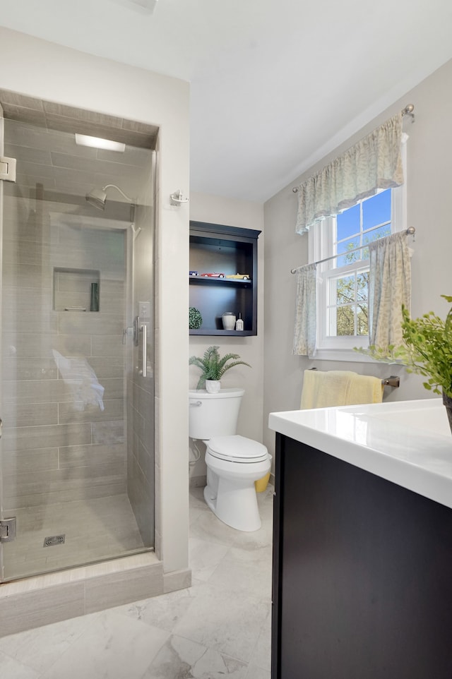 full bath with toilet, a shower stall, vanity, and marble finish floors