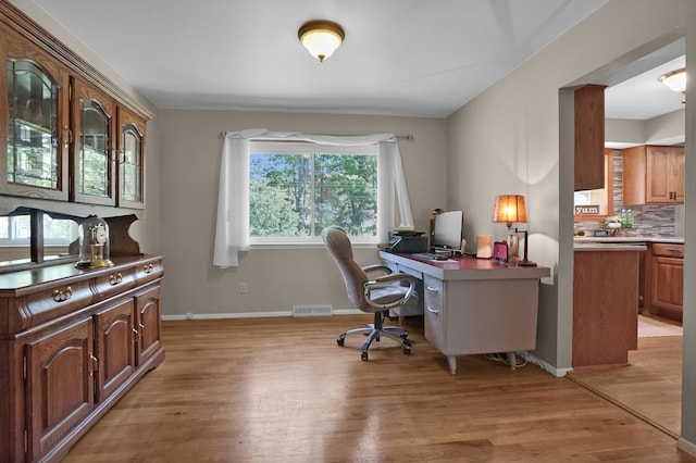 office featuring light wood-style flooring and baseboards