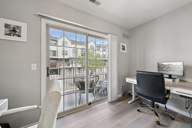 office space with wood finished floors and baseboards