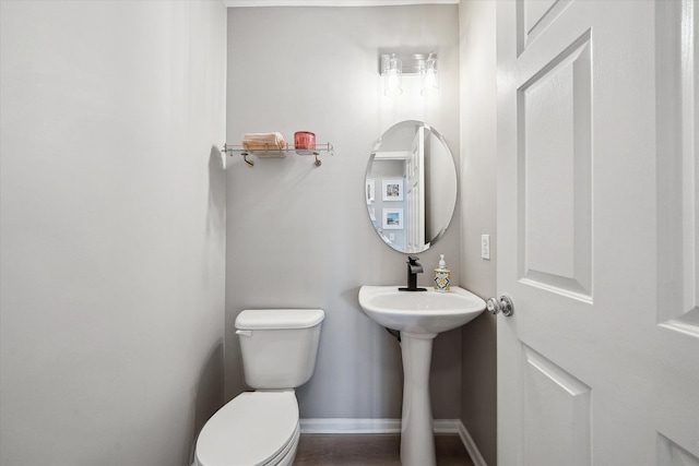 bathroom featuring toilet and baseboards
