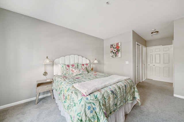 carpeted bedroom featuring baseboards