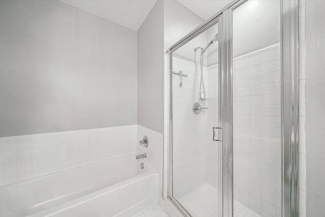 full bath featuring a garden tub and a shower stall
