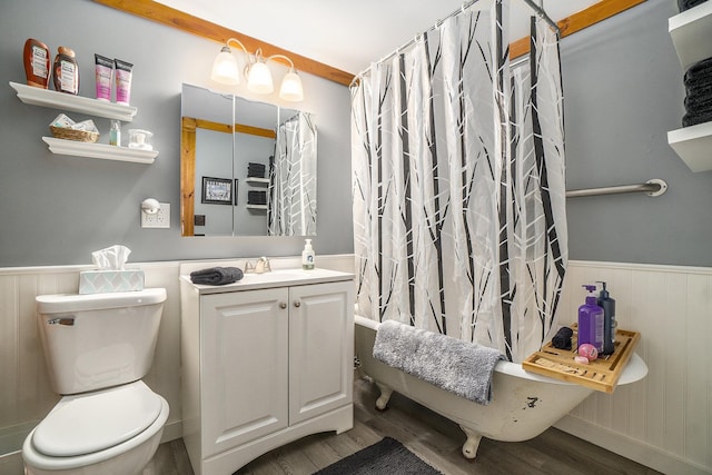 10780 S 29th Rd, Cadillac, MI 49601 - full bathroom featuring wainscoting, wood finished floors, toilet, vanity, and shower / bathtub combination with curtain