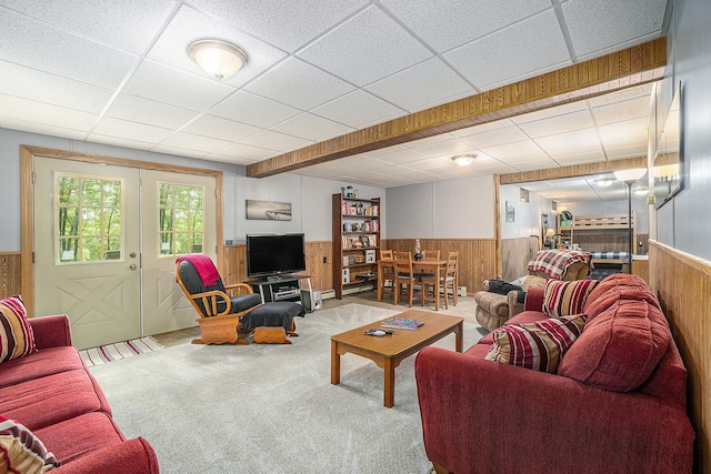 10780 S 29th Rd, Cadillac, MI 49601 - living area with a wainscoted wall, wooden walls, a drop ceiling, carpet, and french doors