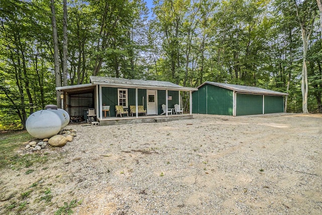 10780 S 29th Rd, Cadillac, MI 49601 - view of front of home with an outdoor structure, metal roof, and view of scattered trees