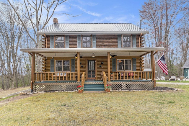 10780 S 29th Rd, Cadillac, MI 49601 - log home featuring log exterior, ceiling fan, covered porch, a chimney, and a front lawn