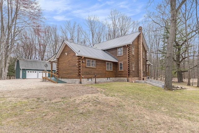 10780 S 29th Rd, Cadillac, MI 49601 - view of home's exterior with log exterior, metal roof, a yard, a chimney, and an outdoor structure