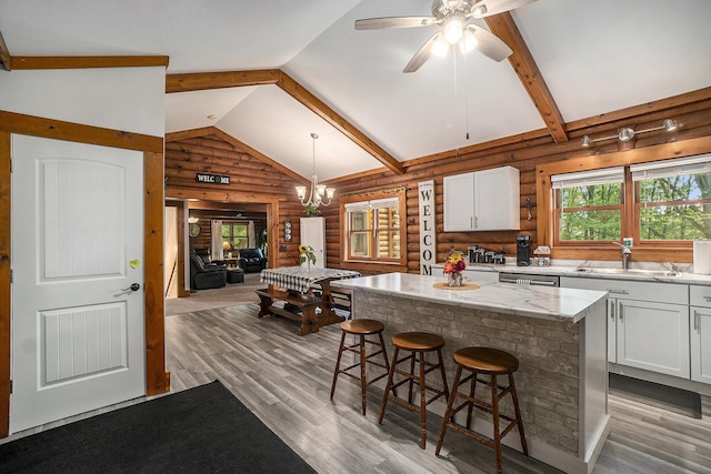 10780 S 29th Rd, Cadillac, MI 49601 - kitchen featuring rustic walls, a sink, dishwasher, white cabinets, and light wood-style flooring