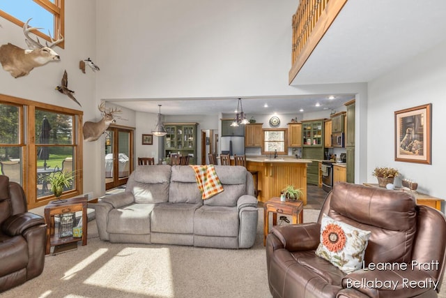 3389 Shultz Rd, Hastings, MI 49058 - living room with a towering ceiling, dark carpet, healthy amount of natural light, and recessed lighting