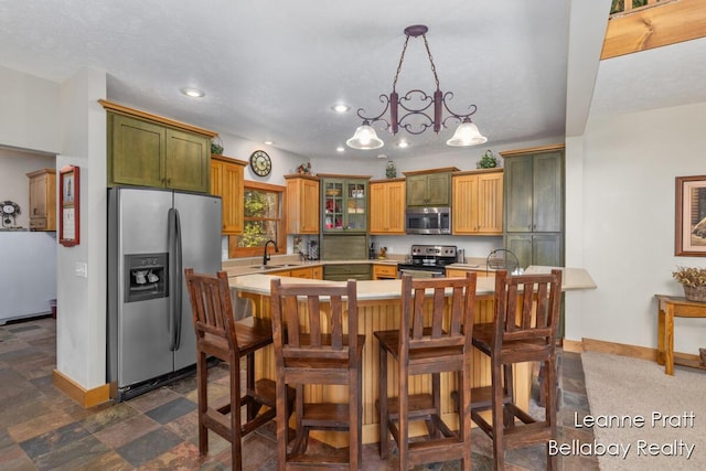 3389 Shultz Rd, Hastings, MI 49058 - kitchen with appliances with stainless steel finishes, a sink, baseboards, light countertops, and recessed lighting
