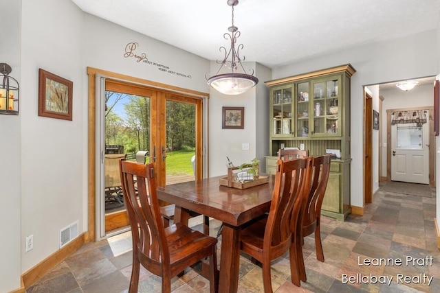 3389 Shultz Rd, Hastings, MI 49058 - dining space with baseboards and dark stone finish floors