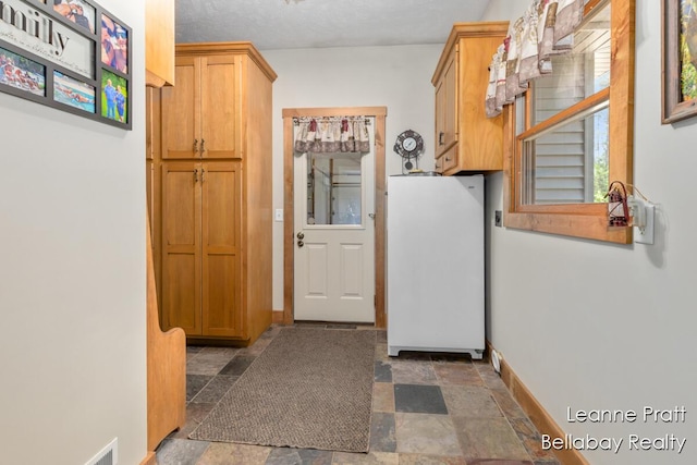 3389 Shultz Rd, Hastings, MI 49058 - doorway to outside with stone finish floors and baseboards
