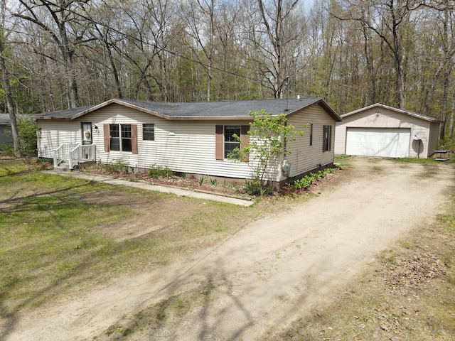 view of front of house with an outdoor structure, crawl space, dirt driveway, and a detached garage