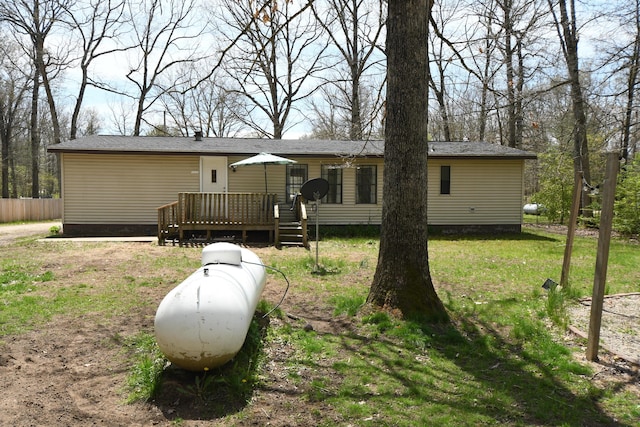 back of property featuring a wooden deck