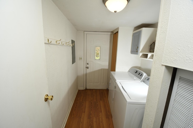 laundry room featuring separate washer and dryer, dark wood finished floors, baseboards, and electric panel