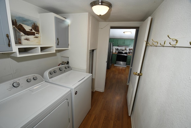 laundry area with washer and clothes dryer, dark wood-type flooring, cabinet space, and a textured wall
