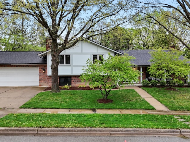 tri-level home featuring a chimney, brick siding, a garage, driveway, and a front lawn