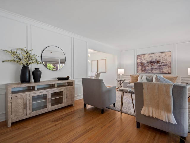 living area with a decorative wall and light wood-type flooring