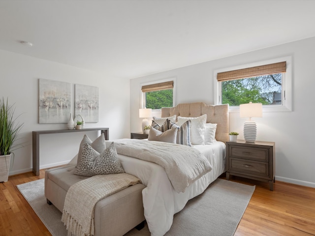 bedroom featuring light wood-style flooring and baseboards