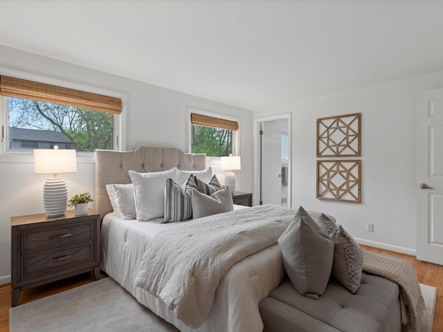 bedroom featuring light wood-style flooring and baseboards