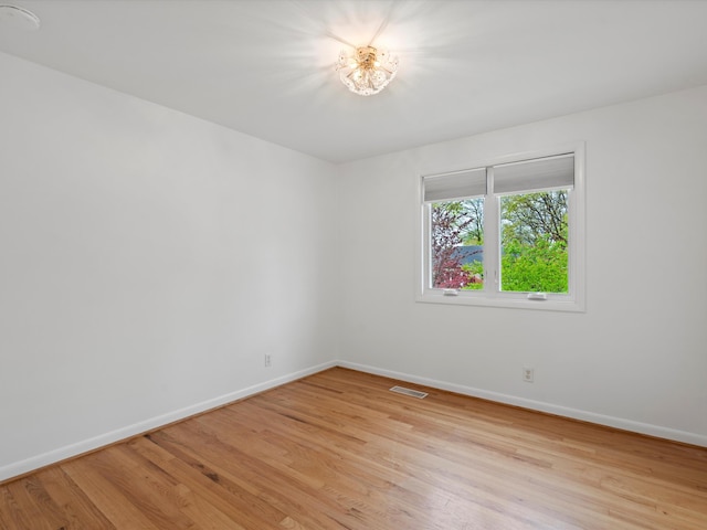 unfurnished room featuring light wood-style flooring and baseboards