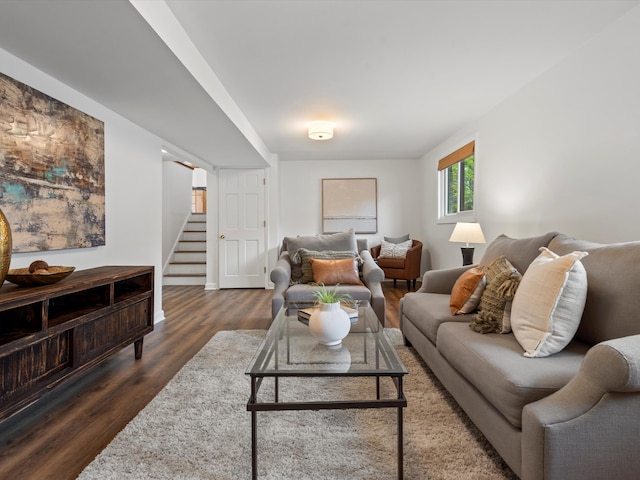 living area featuring stairway and wood finished floors