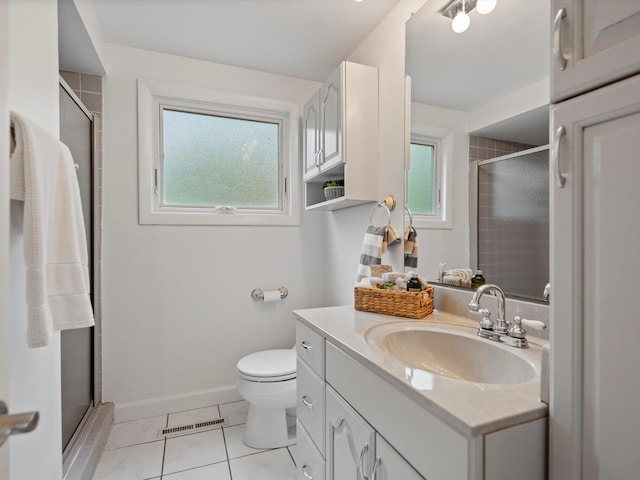 bathroom featuring a stall shower, vanity, toilet, and tile patterned flooring