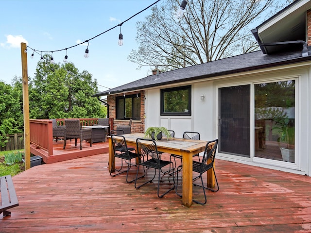 wooden deck with outdoor dining space and an outdoor living space