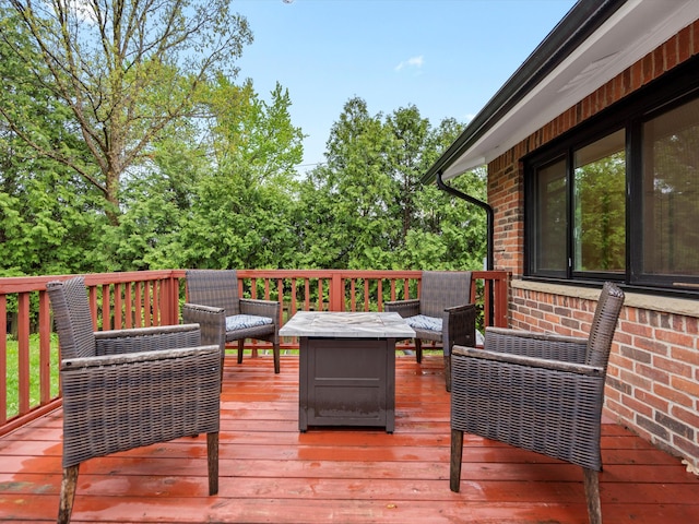 wooden terrace with an outdoor hangout area