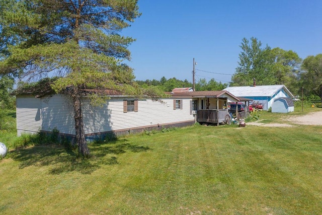 17931 30th Ave, Barryton, MI 49305 - rear view of property with a lawn and covered porch