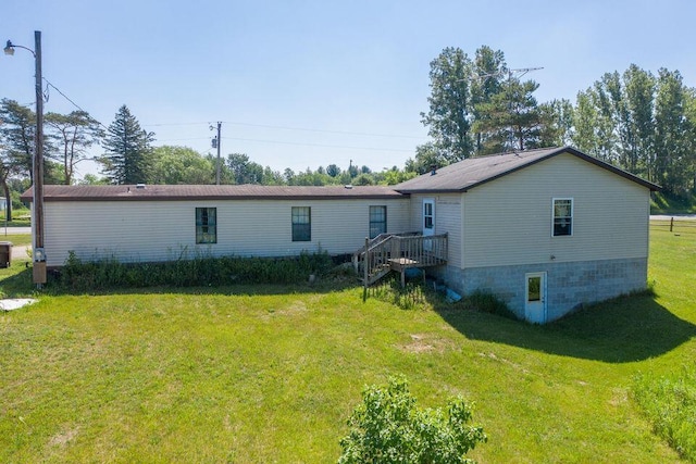 17931 30th Ave, Barryton, MI 49305 - rear view of house with a lawn, stairs, and a wooden deck