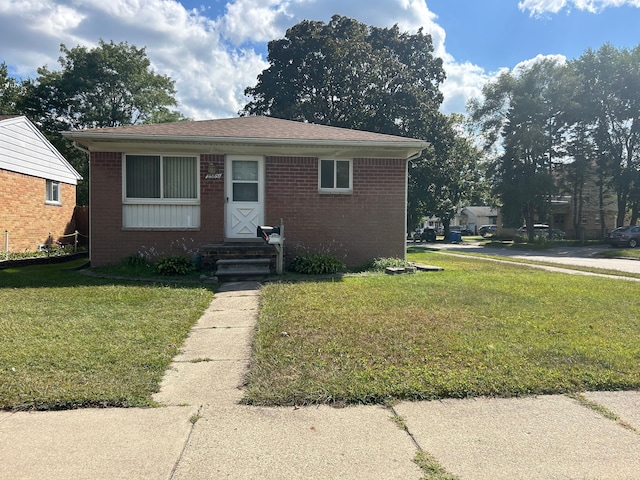 23851 Annapolis St, Dearborn Heights, MI 48125 - bungalow featuring a front lawn and brick siding