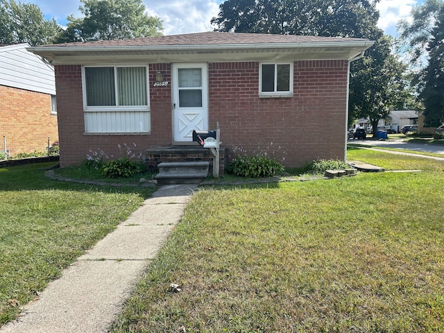 23851 Annapolis St, Dearborn Heights, MI 48125 - view of front of home featuring brick siding and a front lawn