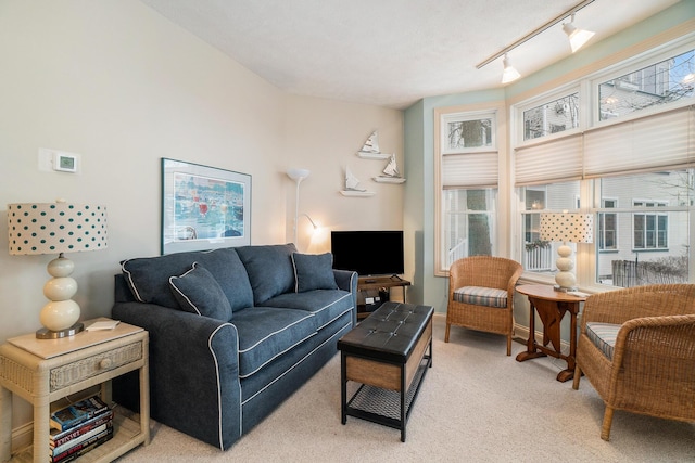 living room featuring light colored carpet and rail lighting