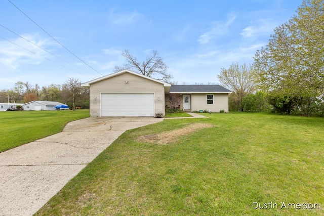 202 Bricker St, Belding, MI 48809 - view of front of home featuring a front yard, concrete driveway, and a garage