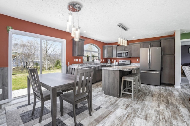 554 Ottawa Trl, Buckley, MI 49620 - dining room with a textured ceiling and light wood finished floors