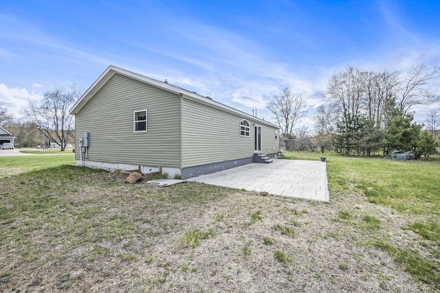 554 Ottawa Trl, Buckley, MI 49620 - view of property exterior with a patio, a lawn, and entry steps