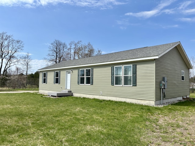 554 Ottawa Trl, Buckley, MI 49620 - manufactured / mobile home featuring a shingled roof and a front lawn