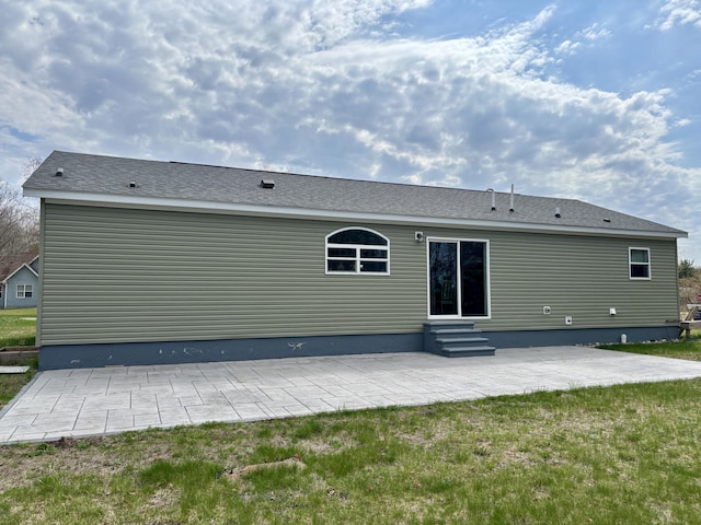 554 Ottawa Trl, Buckley, MI 49620 - back of property with a patio area and entry steps