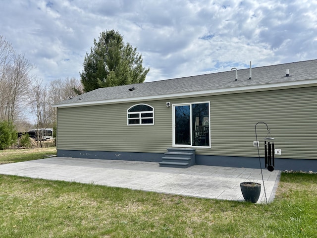 554 Ottawa Trl, Buckley, MI 49620 - rear view of property featuring entry steps, a patio, and a lawn