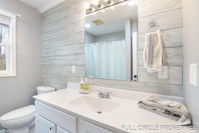full bathroom with vanity, toilet, wooden walls, and a shower with curtain