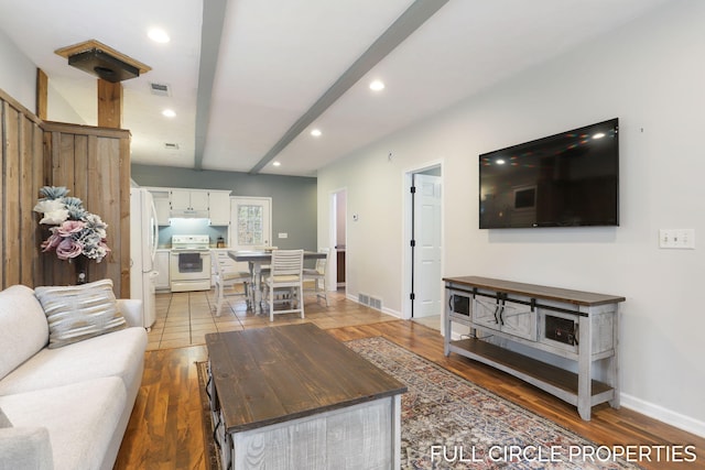 living area featuring recessed lighting, baseboards, and light wood finished floors